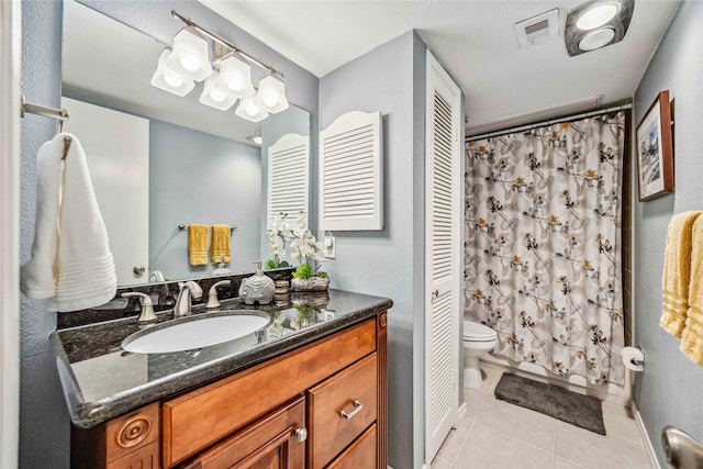 bathroom with vanity, tile patterned floors, and toilet