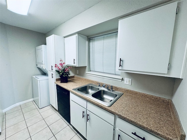 kitchen featuring white cabinetry, sink, light tile patterned floors, stacked washer / dryer, and dishwasher