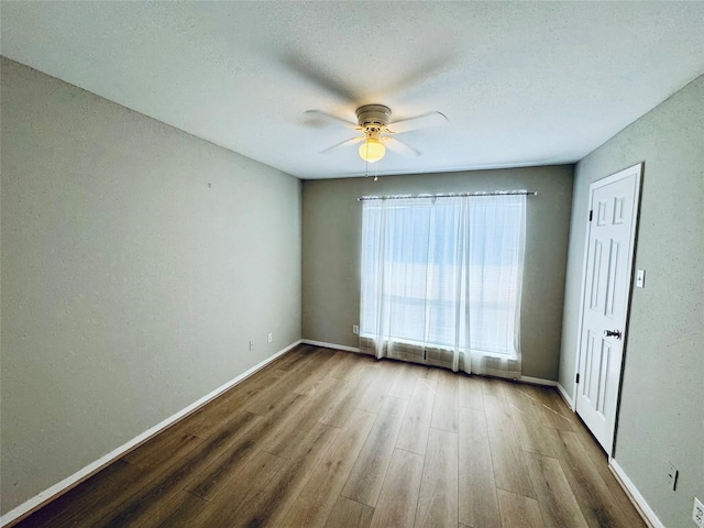 spare room with wood-type flooring and ceiling fan