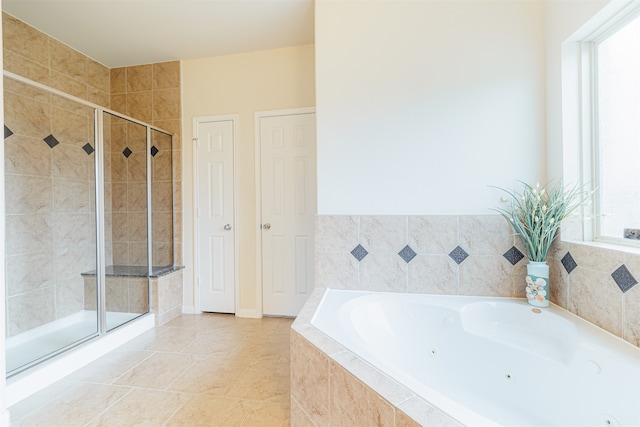 bathroom with independent shower and bath, tile patterned flooring, and a healthy amount of sunlight