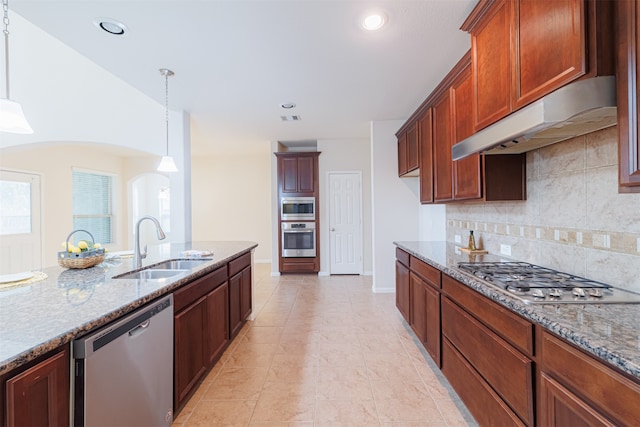 kitchen with tasteful backsplash, light stone countertops, hanging light fixtures, and stainless steel appliances