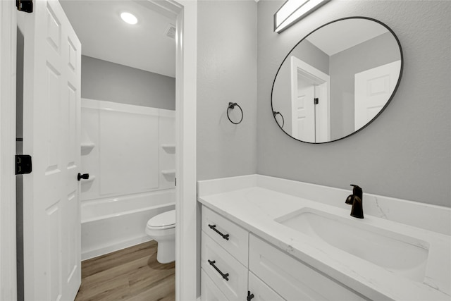 full bathroom with hardwood / wood-style floors, vanity, toilet, and bathtub / shower combination