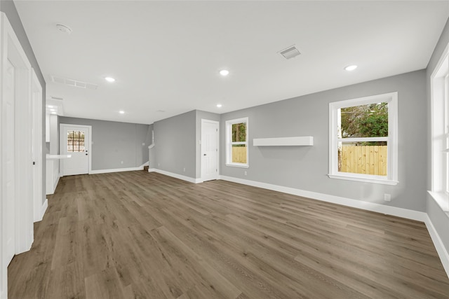 unfurnished living room with plenty of natural light and wood-type flooring