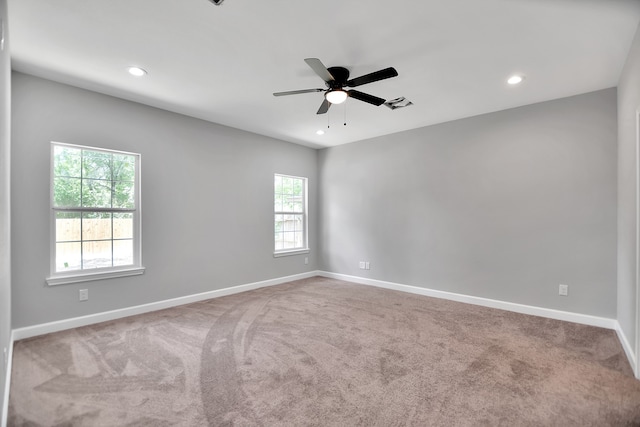 spare room featuring carpet flooring and ceiling fan