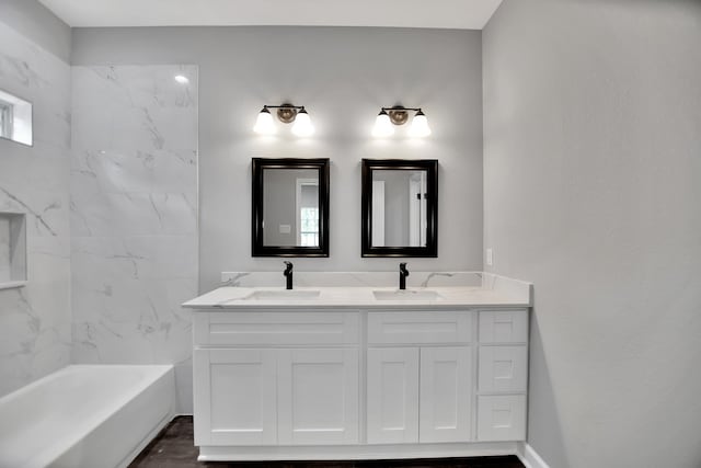 bathroom with vanity and tiled shower / bath combo