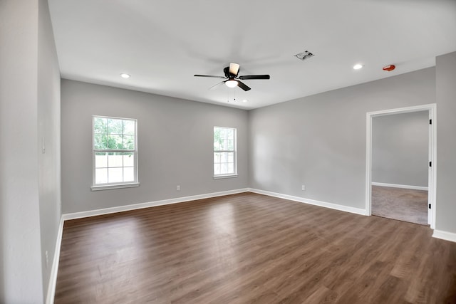 empty room featuring ceiling fan and dark hardwood / wood-style floors