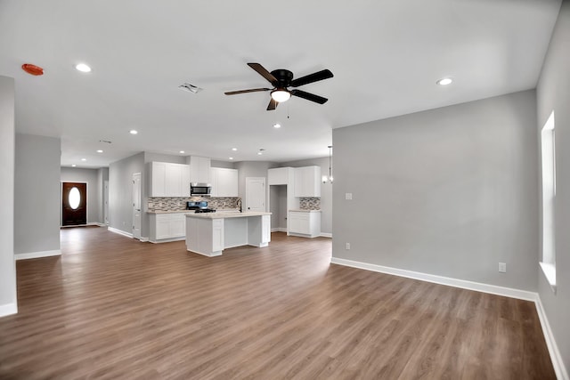 unfurnished living room with ceiling fan and light hardwood / wood-style flooring