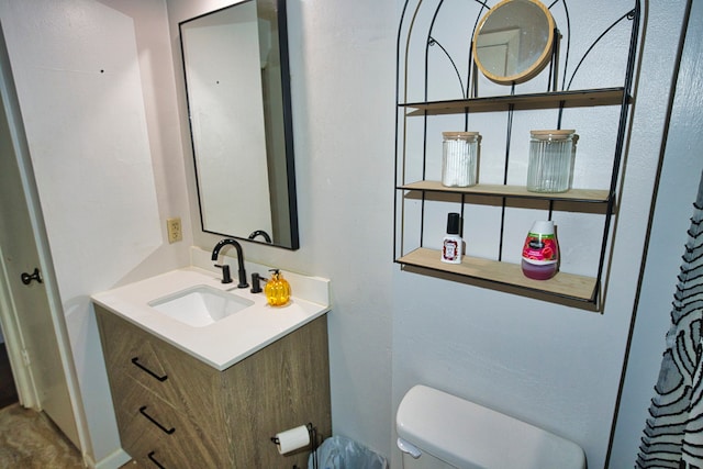 bathroom featuring toilet and vanity