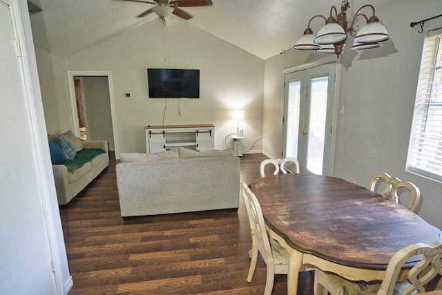 dining room featuring french doors, vaulted ceiling, ceiling fan with notable chandelier, and dark hardwood / wood-style flooring