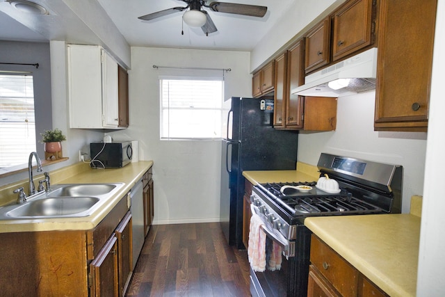 kitchen featuring appliances with stainless steel finishes, sink, ceiling fan, and dark hardwood / wood-style flooring