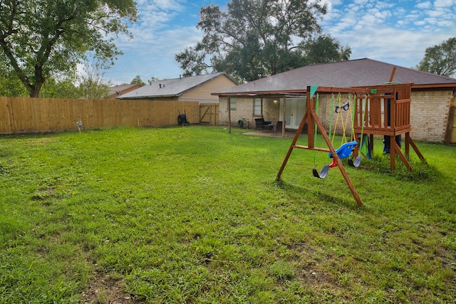 view of yard with a playground and a patio