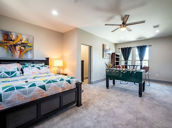 bedroom with light colored carpet and ceiling fan