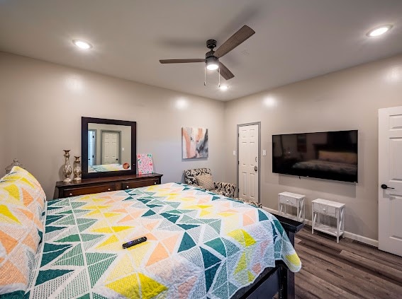 bedroom featuring dark hardwood / wood-style flooring and ceiling fan