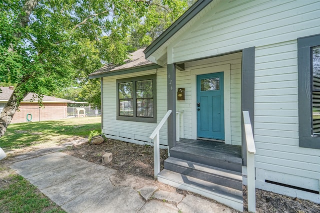 doorway to property featuring a yard