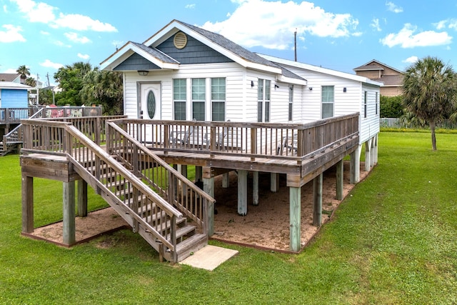 back of house featuring a wooden deck and a yard