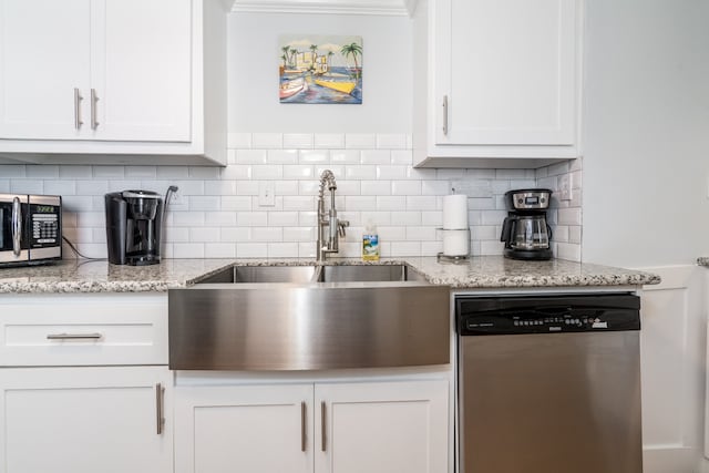 kitchen featuring stainless steel appliances, ornamental molding, light stone countertops, backsplash, and white cabinets