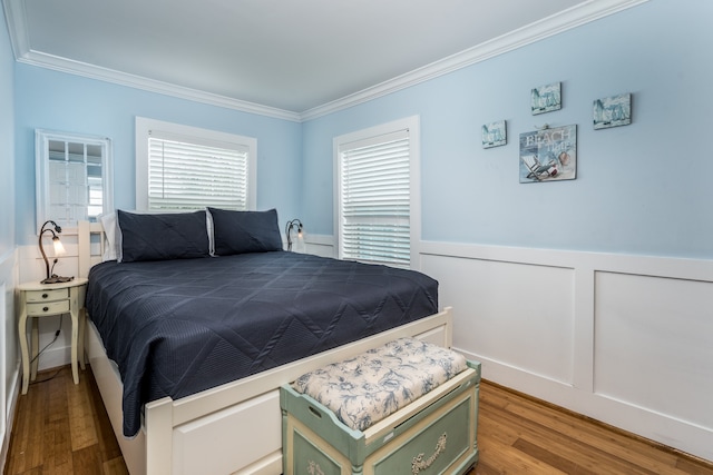 bedroom with light wood-type flooring and ornamental molding