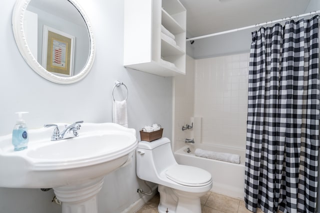 full bathroom with tile patterned flooring, shower / bath combo with shower curtain, toilet, and sink