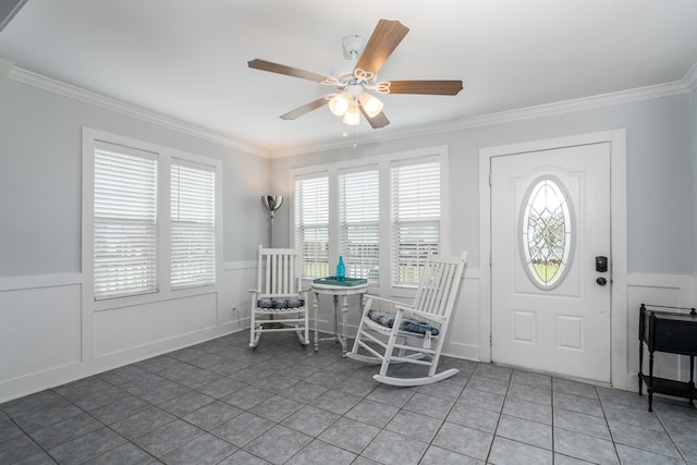 entrance foyer with ornamental molding, plenty of natural light, ceiling fan, and tile patterned floors