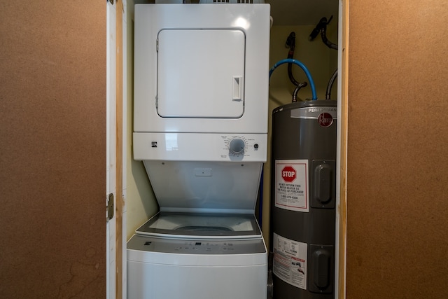 laundry room featuring electric water heater and stacked washer and dryer