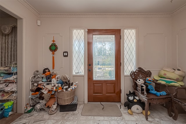 entryway featuring ornamental molding and plenty of natural light