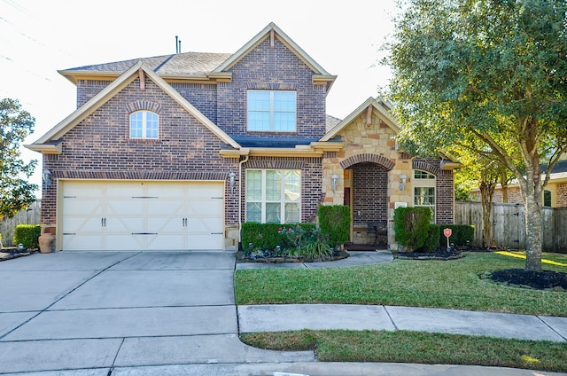 view of front of property with a garage and a front lawn