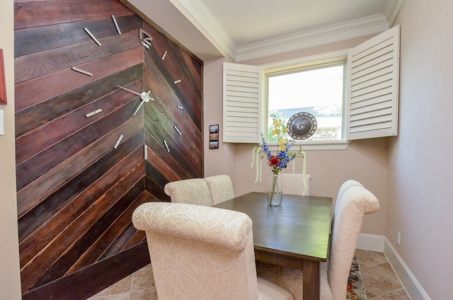 tiled dining area featuring crown molding