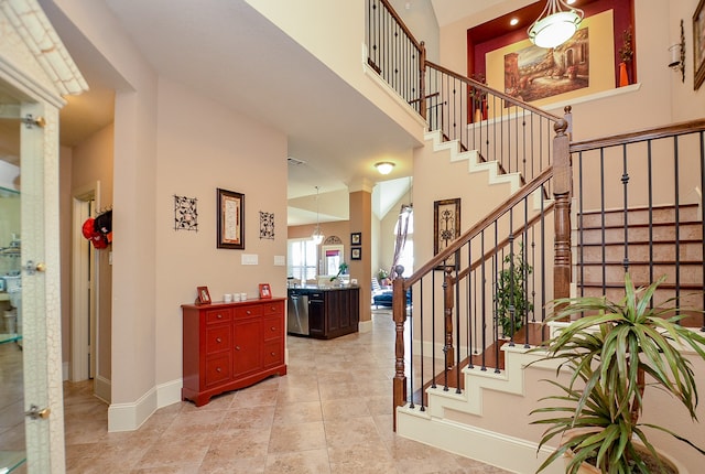 entrance foyer with a high ceiling and ornate columns