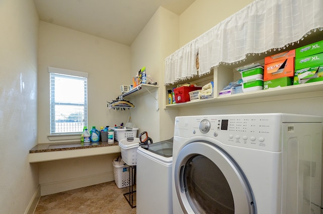 laundry room with separate washer and dryer and light tile patterned floors