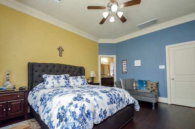 bedroom featuring ornamental molding, dark hardwood / wood-style flooring, ceiling fan, and ensuite bath