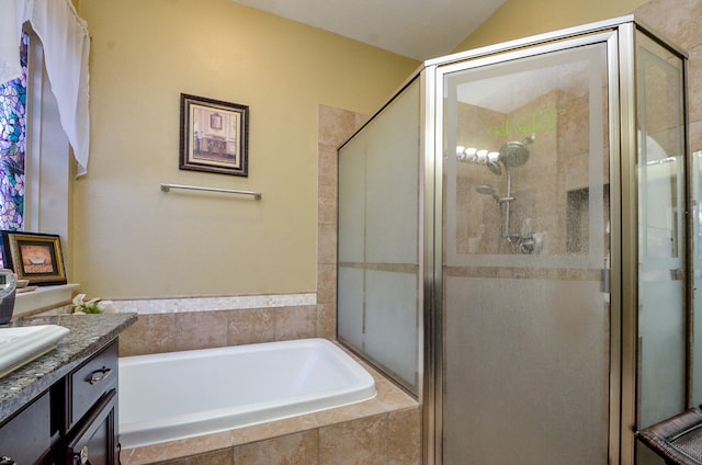 bathroom with vanity and separate shower and tub