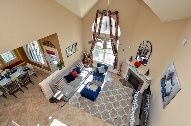 living room with high vaulted ceiling, a healthy amount of sunlight, and ceiling fan