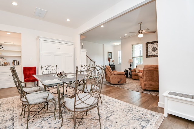 dining room featuring wood-type flooring and ceiling fan