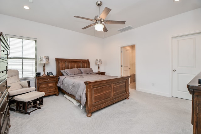 carpeted bedroom featuring ceiling fan and ensuite bathroom