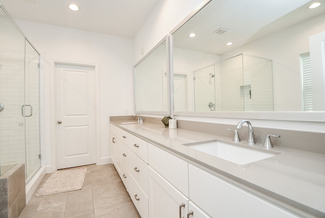 bathroom with tile patterned flooring, an enclosed shower, and vanity