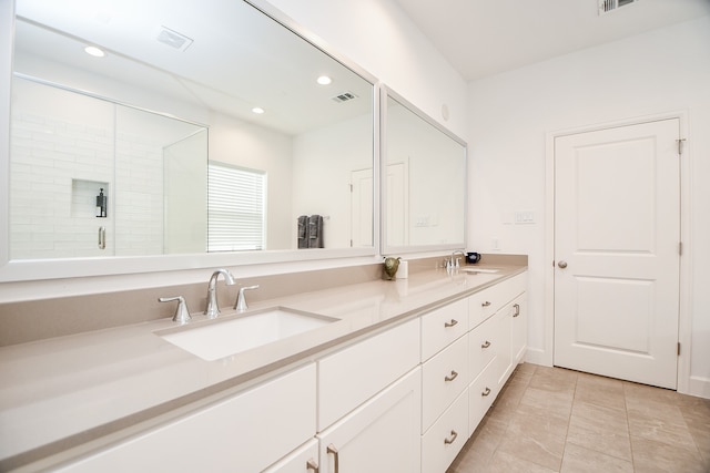 bathroom featuring walk in shower, vanity, and tile patterned floors