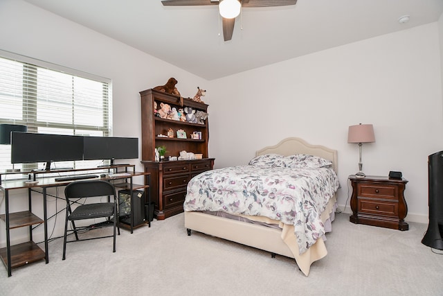 bedroom featuring light colored carpet and ceiling fan