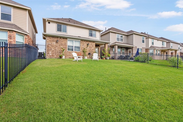 rear view of property with a yard