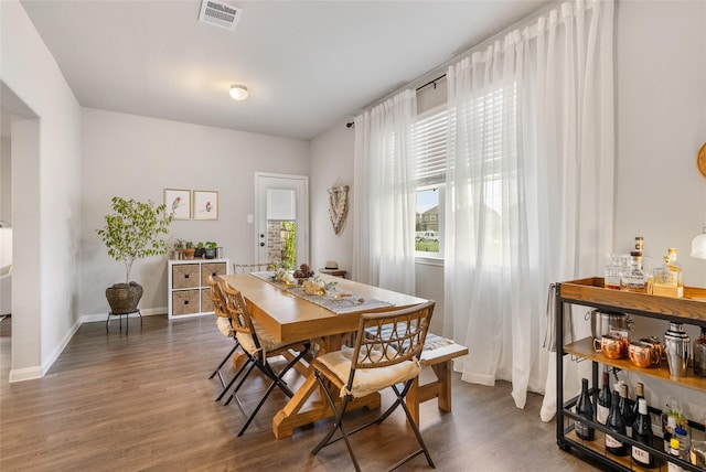 dining space with dark wood-type flooring