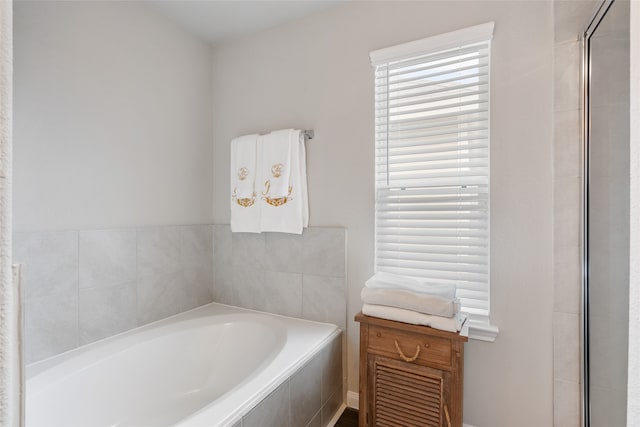 bathroom featuring tiled bath