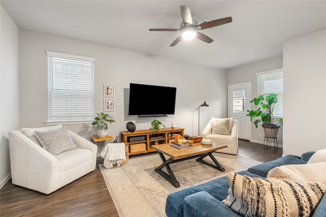 living room with dark hardwood / wood-style flooring and ceiling fan