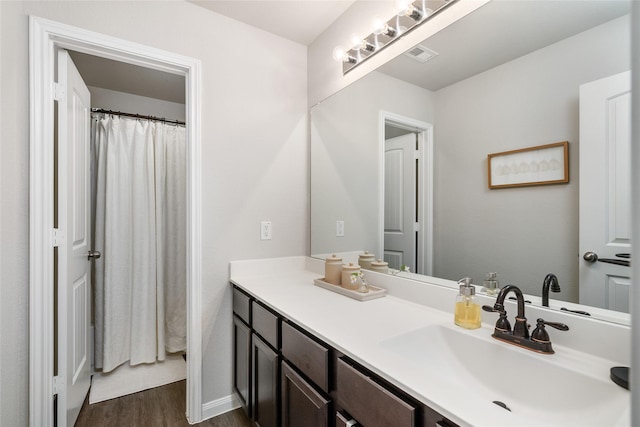 bathroom with vanity and wood-type flooring