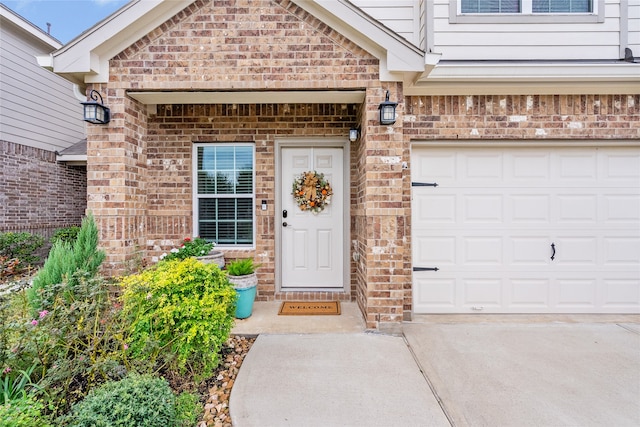 doorway to property with a garage