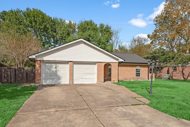 ranch-style house featuring a front yard and a garage