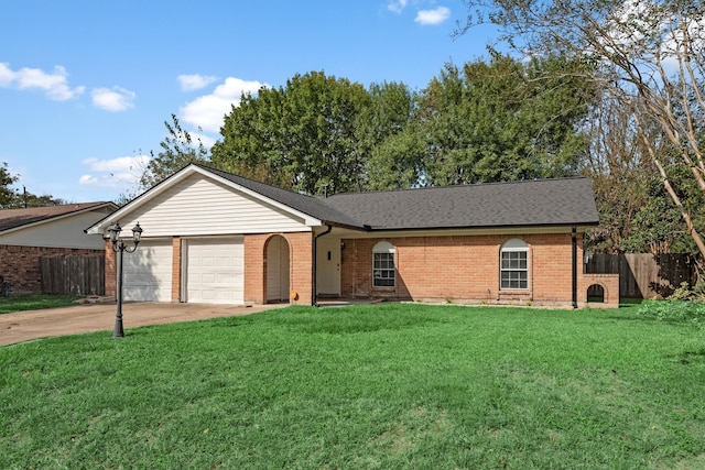 ranch-style house featuring a garage and a front lawn