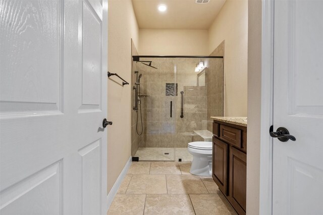 bathroom with vanity, toilet, and an enclosed shower