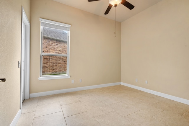 spare room with light tile patterned floors and ceiling fan