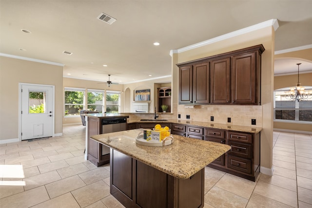 kitchen featuring light tile patterned flooring, kitchen peninsula, tasteful backsplash, ceiling fan with notable chandelier, and a kitchen island