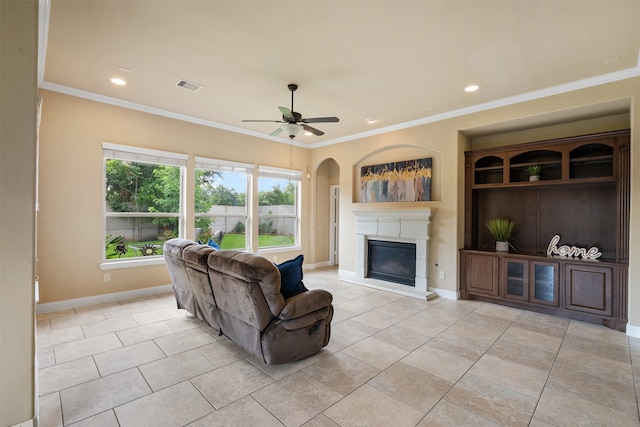 living room featuring ceiling fan, light tile patterned floors, and ornamental molding