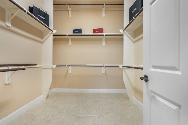 walk in closet with tile patterned flooring